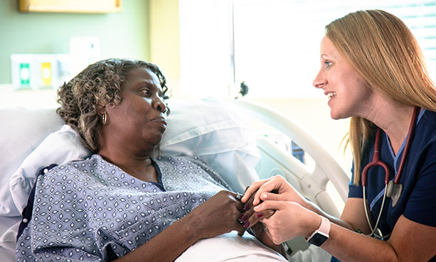 nurse and patient holding hands